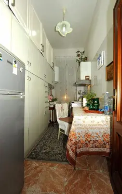 a kitchen with two beds and a table in a room at Casa Bianca in Rome