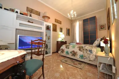 a bedroom with a bed and a desk and a television at Casa Bianca in Rome