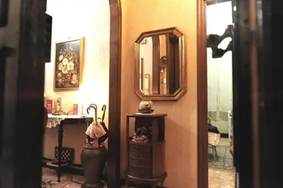 a hallway with a mirror and a dresser in a room at Casa Bianca in Rome