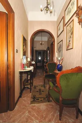a hallway with chairs and a table in a room at Casa Bianca in Rome