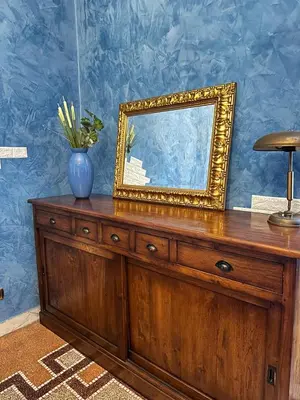 a wooden dresser with a mirror and a vase on it at L'Angolo di Roma in Rome