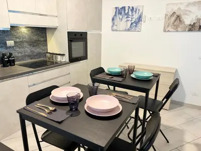 a kitchen with two tables with plates on it at Roma Elena in Rome