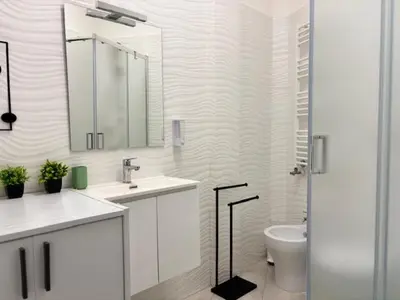 a bathroom with a sink and a toilet and a mirror at Roma Elena in Rome