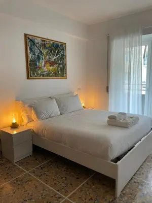 a white bedroom with a large bed and a window at Vatican Apartment Cipro in Rome