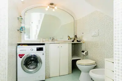a bathroom with a washing machine and a sink at Locazione turistica Via Caltanissetta in Rome