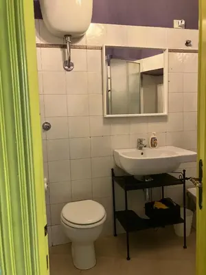a bathroom with a toilet and a sink at CasaPigneto34 in Rome