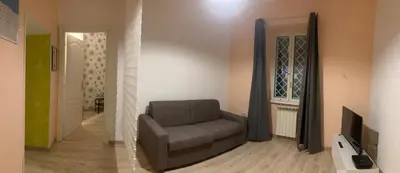 a living room with a chair and a television at CasaPigneto34 in Rome