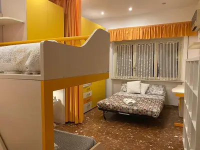 a small room with a bunk bed and a couch at La Casa oltre il Parco in Rome