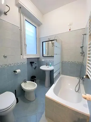a bathroom with a tub and a toilet and a sink at Gregory Retreat in Rome