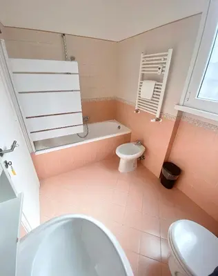 a bathroom with a tub and a toilet and a sink at Gregory Retreat in Rome