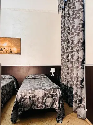 a bedroom with a bed and a curtain at Funny place in Rome