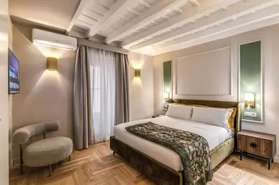 a hotel room with a bed and a chair at Appartamento del Fico in Rome