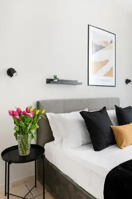 a couch with a vase of flowers on a table at V HOME San Lorenzo in Rome