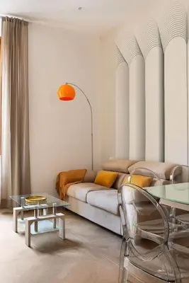 a living room with a couch and tables at Idyllia - Magnificent Central Apartment in Rome