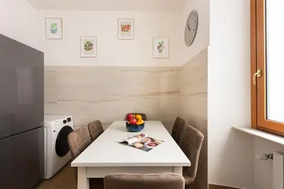 a small kitchen with a white table and chairs at Idyllia - Magnificent Central Apartment in Rome
