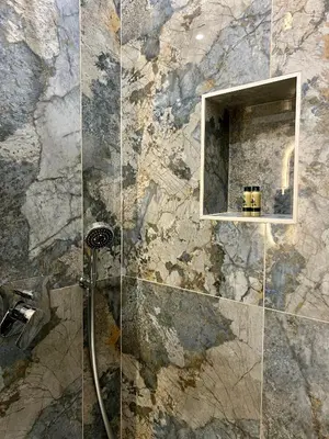 a bathroom with a shower with a stone wall at Maison Almo Guesthouse in Rome