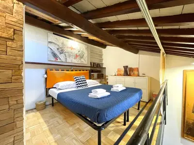 a bedroom with a blue bed with towels on it at Trastevere Lovely Loft in Rome