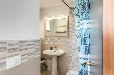 a bathroom with a sink and a mirror at Romantic Vatican Attic Villa Pamphili in Rome