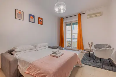 a bedroom with a bed and a table and a window at Orange Blue House 1Bedr Metro Re di Roma in Rome