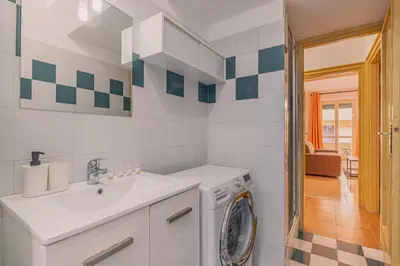 a bathroom with a washing machine and a sink at Orange Blue House 1Bedr Metro Re di Roma in Rome