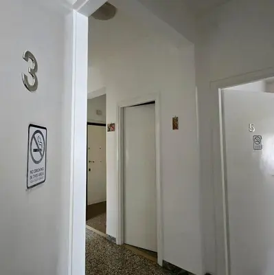 an empty room with a white wall and a door at Domus Passerini in Rome