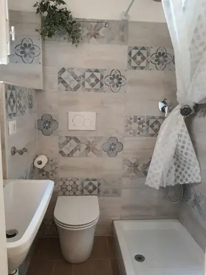 a small bathroom with a toilet and a sink at Daisy House in Rome