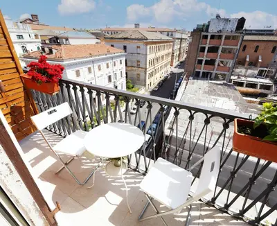 a balcony with a table and chairs and a view of a city at Key Rome Center in Rome
