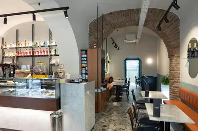 a restaurant with a counter and tables and chairs at Key Rome Center in Rome