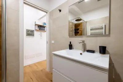 a bathroom with a white sink and a mirror at Little House 15 in Rome