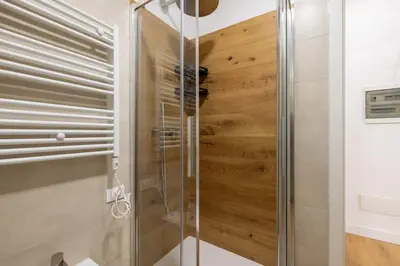 a shower with a glass door in a bathroom at Little House 15 in Rome