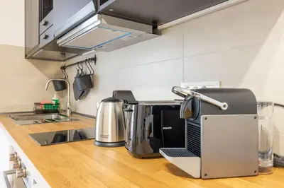 a kitchen with a counter with a toaster and a microwave at Little House 15 in Rome