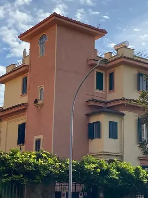 a building with a street light in front of it at Alloggio Turistico al Villino del Melograno in Rome
