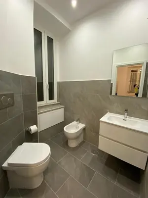 a bathroom with a toilet and a sink at Maison Niccolini Gianicolo in Rome