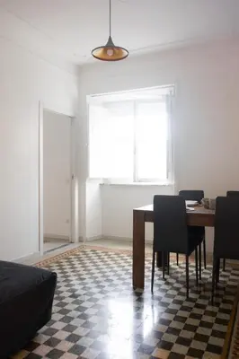 a dining room with a table and chairs and a window at Imperia House in Rome