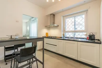 a kitchen with a counter and a sink and a window at Roma-Gemelli - Free Parking - Private Garden in Rome