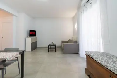 a living room with a bed and a couch at Roma-Gemelli - Free Parking - Private Garden in Rome