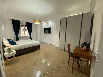 a bedroom with a bed and a table and a desk at Vacanze Romane da Manuela in Rome