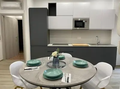 a kitchen with a table with green plates on it at Vacanze Romane da Manuela in Rome