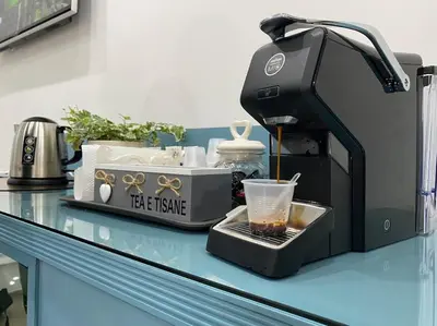 a coffee machine sitting on a counter with a cup at Vacanze Romane da Manuela in Rome