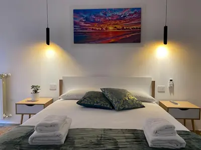 a bedroom with a large bed with two towels on it at Vacanze Romane da Manuela in Rome