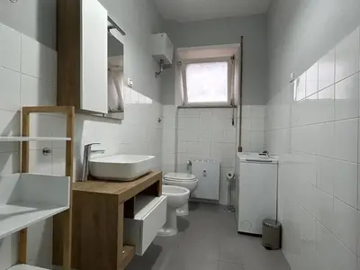 a white bathroom with a sink and a toilet at 5Piano Ascensore Near Vaticano Ideale per Famiglie in Rome