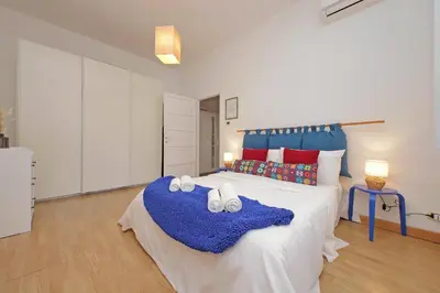 a bedroom with a large bed with towels on it at San Pietros Flat by DomusDimore in Rome