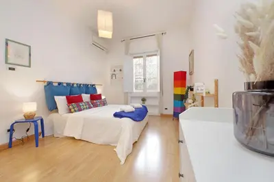 a living room with a bed and a couch at San Pietros Flat by DomusDimore in Rome