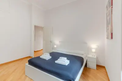 a white room with a bed with towels on it at Contemporary Flat in Trastevere in Rome