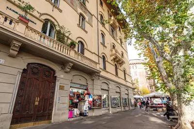 a building with a store on the side of a street at Contemporary Flat in Trastevere in Rome