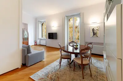 a living room with a table and chairs and a couch at Contemporary Flat in Trastevere in Rome