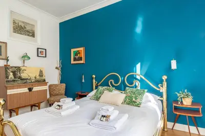 a blue bedroom with a bed with towels on it at iFlat Charming Vintage Apartment in Esquilino in Rome