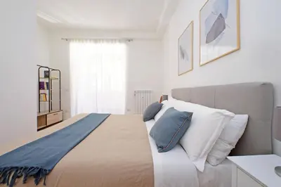 a bedroom with a large bed with blue and white pillows at YCH-Delightful flat near San Giovanni in Rome