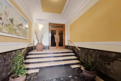 a staircase with potted plants in a hallway at YCH-Delightful flat near San Giovanni in Rome