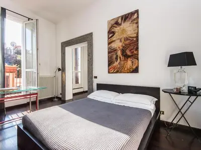 a bedroom with a bed and a painting on the wall at Luxury Spanish Steps Terrace in Rome